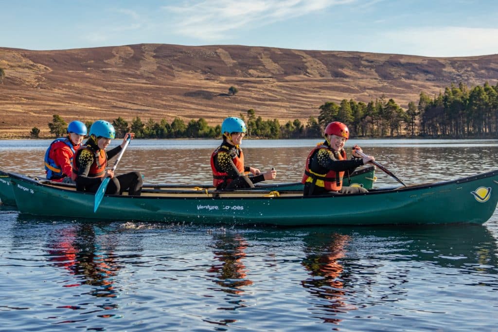 3 people canoeing