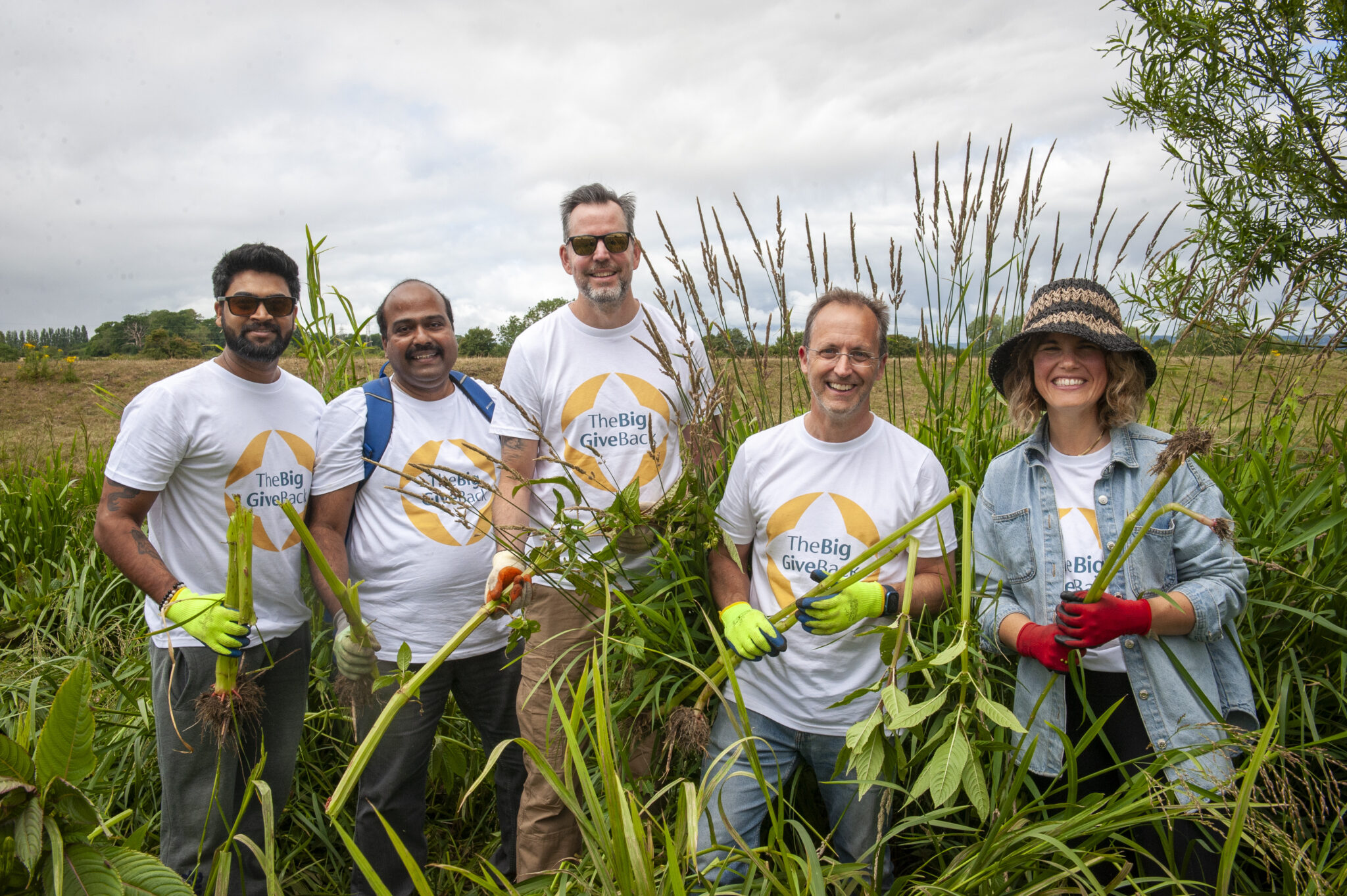 Employees in a field smiling