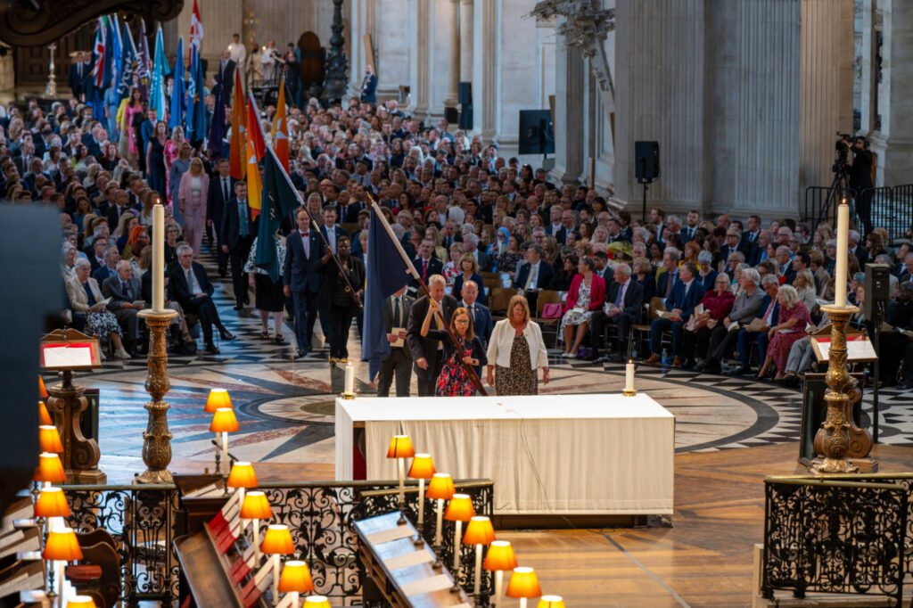 Flags of Member Companies of the Benefact Group are processed through the Cathedral and placed under the Dome.