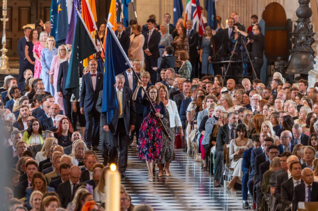 Flags of Member Companies of the Benefact Group are processed through the Cathedral and placed under the Dome.