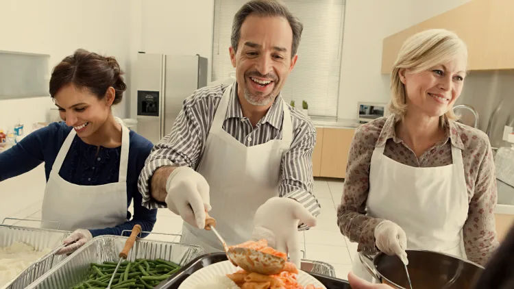 people smiling serving food