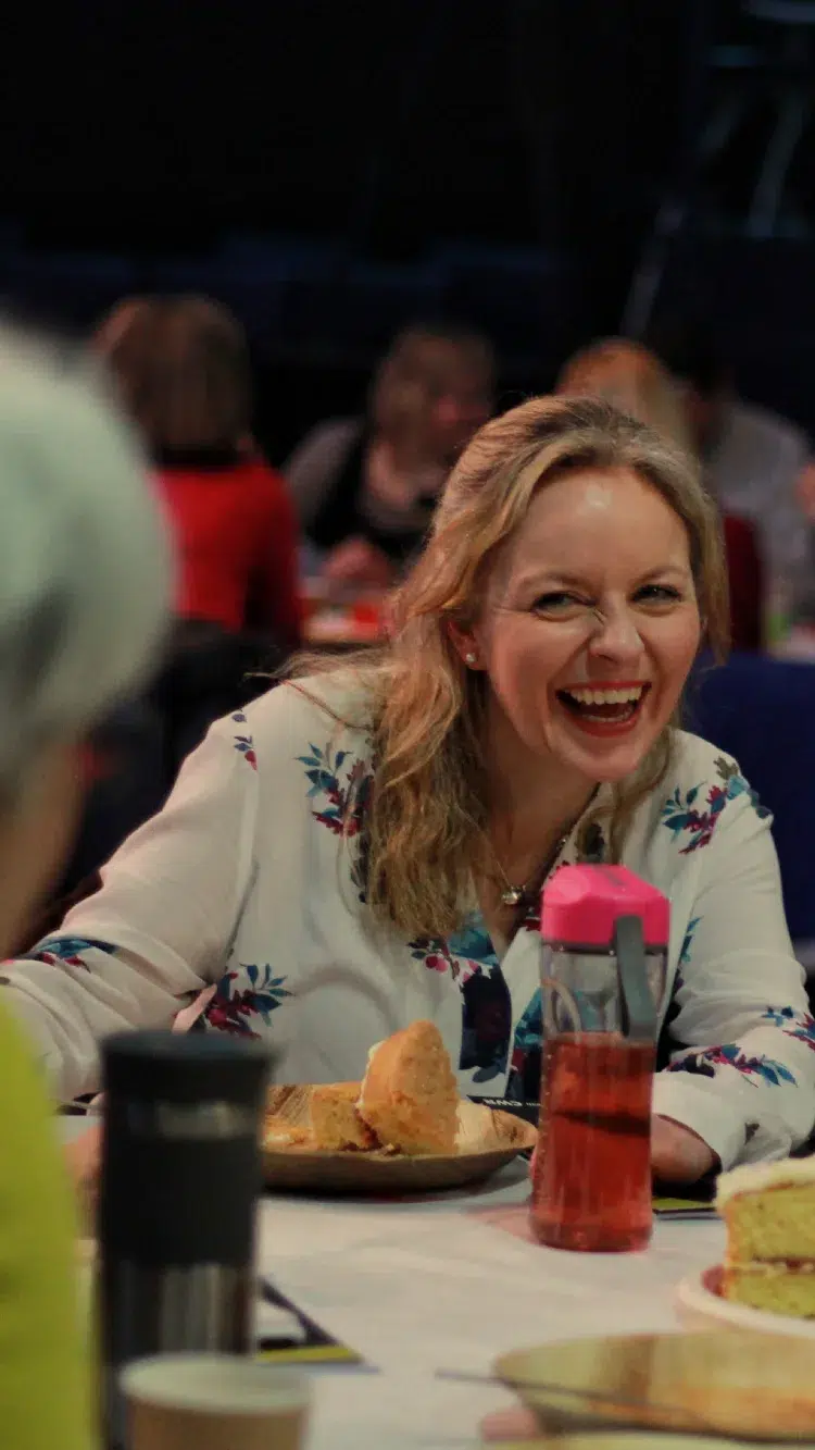 women laughing at a table