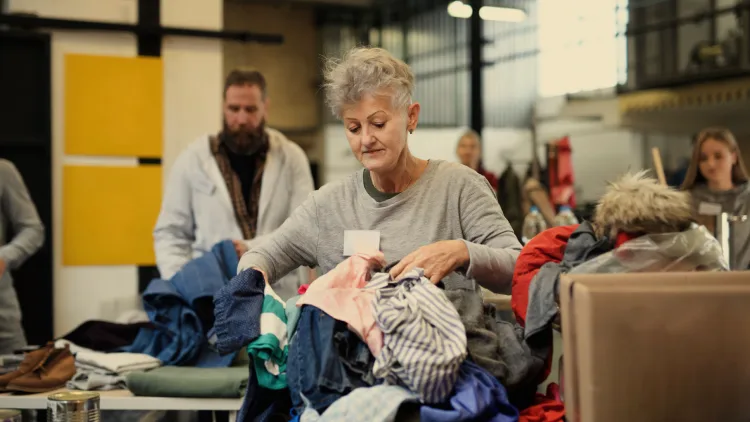 women handling clothes charity